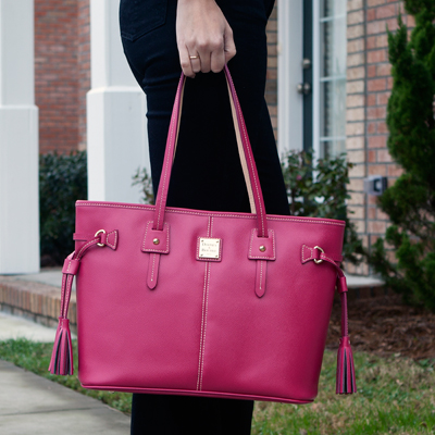 DOONEY & BOURKE® Davis Tassel Shopper Bag - This gorgeous, raspberry red leather bag with leather tassel details measures 14”x11”x5½ “.  Fabric lining inside also features cell phone pocket, key hook and zippered side pocket. 